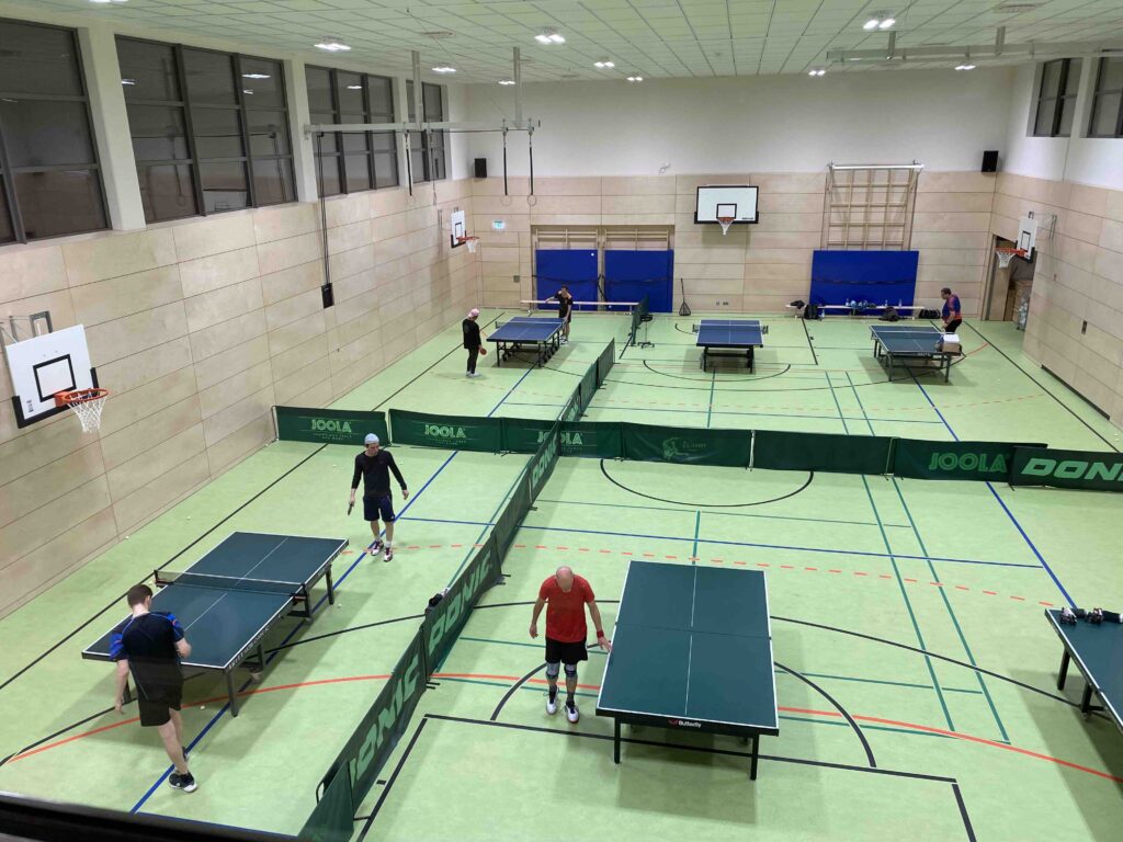 Bild in die Turnhalle mit Tischtennistischen von oben